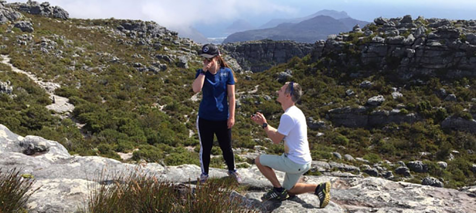 Matthew Wilkinson proposing to Chloe Pearce on a mountain.